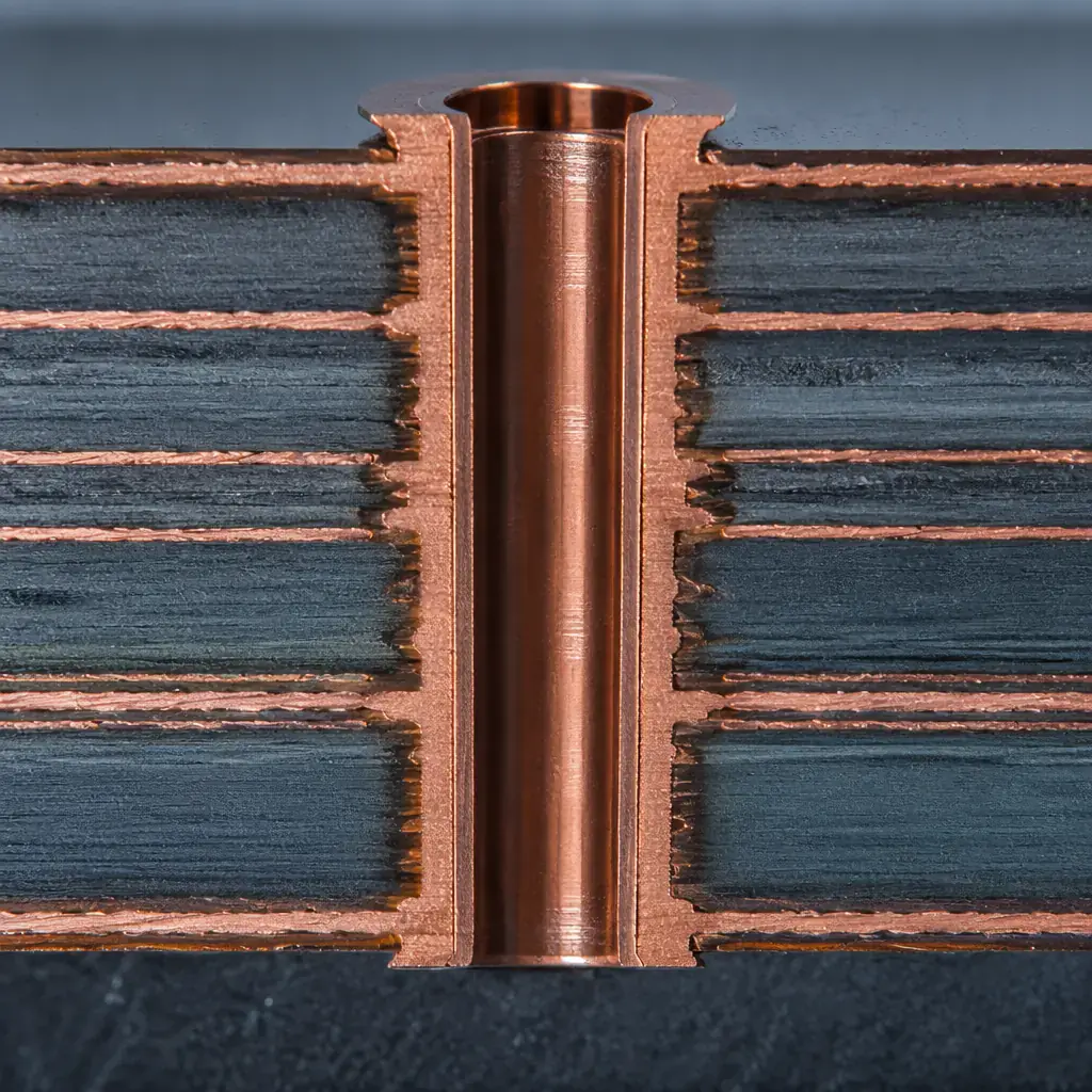 Cross-section macro photograph of 6oz heavy copper PCB trace showing thick copper profile and plated via barrel for high-current power distribution